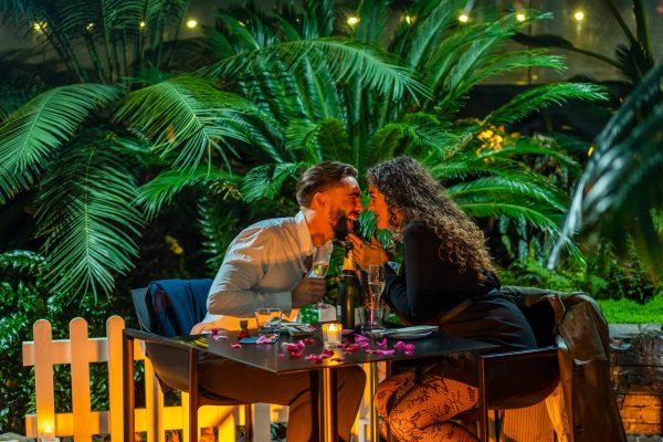 The happy couple about to kiss at the table after the marriage proposal at Sky Garden in London
