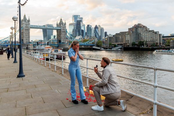 Marriage proposal at Tower Bridge Butlers Wharf Side Man on the knee